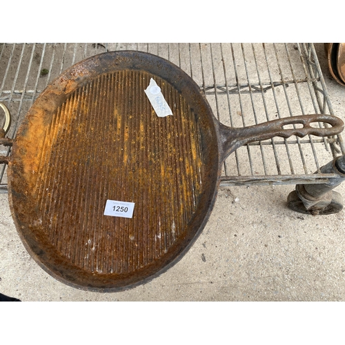 1250 - A VINTAGE CAST IRON GRIDDLE PAN