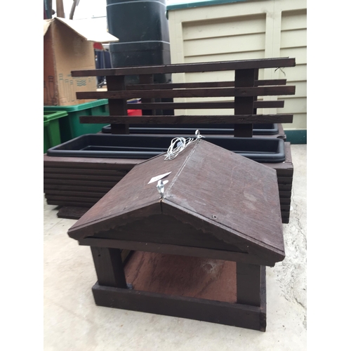 1407 - TWO WOODEN TROUGH PLANTERS AND A WOODEN BIRD TABLE TOP