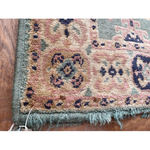 1997 - A SMALL GREEN PATTERNED RUG