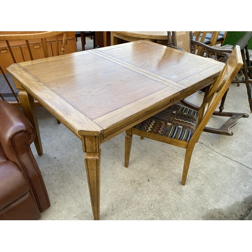 2074 - A MODERN EXTENDING DINING TABLE WITH CANTED CORNERS AND TAPERED LEGS, COMPLETE WITH ONE DINING CHAIR