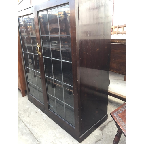 2184 - A GLAZED AND LEADED TWO DOOR BOOKCASE