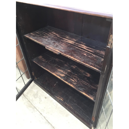 2184 - A GLAZED AND LEADED TWO DOOR BOOKCASE