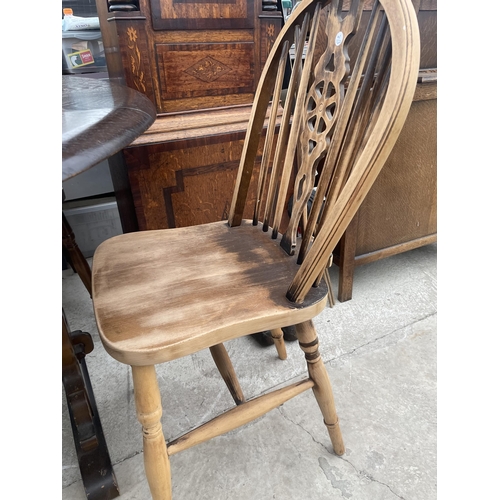 2344 - A MODERN OAK DROP-LEAF DINING TABLE AND FOUR WHEEL-BACK WINDSOR CHAIRS