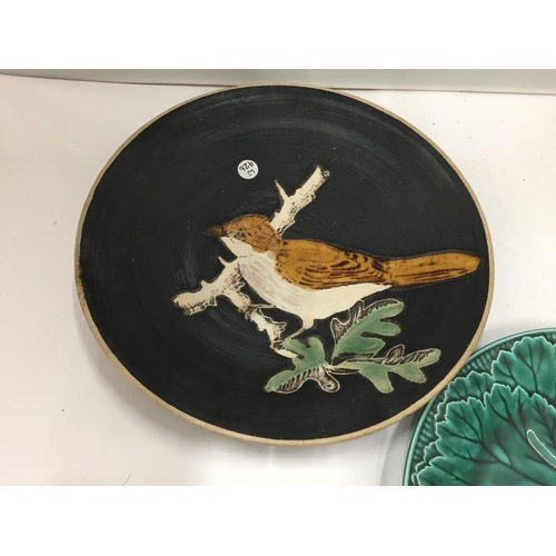 67 - TWO COLLECTABLE PLATES, ONE A GREEN WEDGWOOD CABBAGE LEAF PLUS A STUDIO POTTERY PLATE WITH A BIRD DE... 