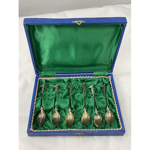 19 - A BOXED SET OF SIX DECORATIVE SPOONS MARKED 800