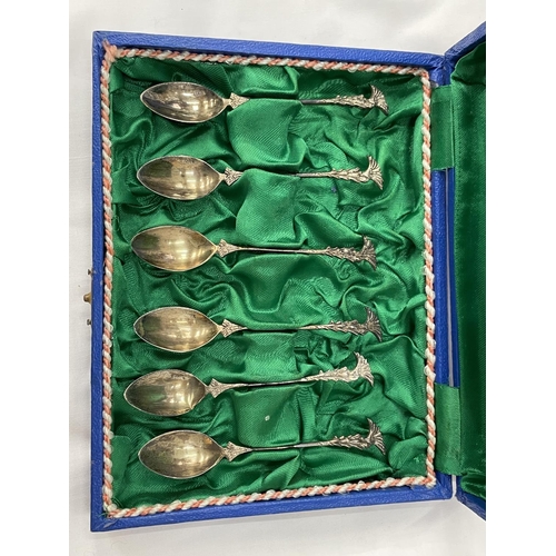 19 - A BOXED SET OF SIX DECORATIVE SPOONS MARKED 800