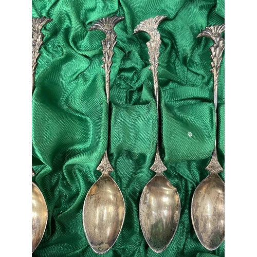 19 - A BOXED SET OF SIX DECORATIVE SPOONS MARKED 800