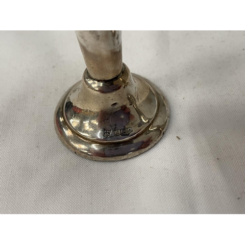 22 - THREE HALLMARKED BIRMINGHAM SILVER ITEMS TO INCLUDE A CANDLESTICK AND A PAIR OF BUD VASES