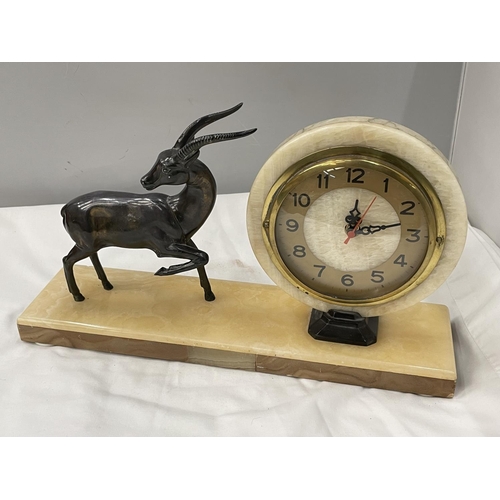 30A - A MARBLE CIRCULAR CLOCK ON A MARBLE BASE WITH A METAL GAZELLE DECORATION BASE 40CM X 10CM