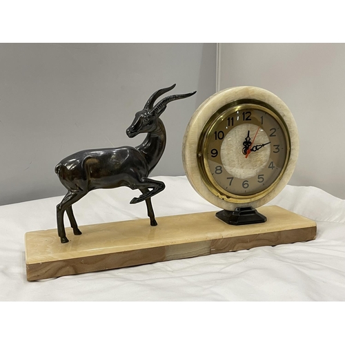 30A - A MARBLE CIRCULAR CLOCK ON A MARBLE BASE WITH A METAL GAZELLE DECORATION BASE 40CM X 10CM