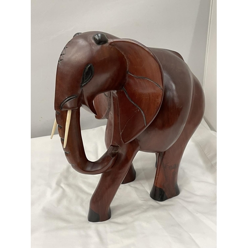 34 - A LARGE HARDWOOD ELEPHANT MODEL HEIGHT 38CM