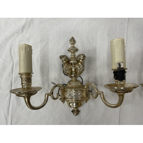 45 - A PAIR OF WHITE METAL DOUBLE WALL LIGHTS WITH CHERUB STYLE DESIGN