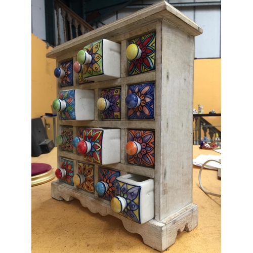 54 - A WHITE PAINTED PINE MINIATURE CHEST WITH SIXTEEN CERAMIC DRAWERS (ONE A/F)