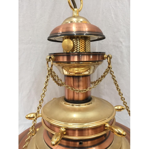 56 - AN UNUSUAL BRASS AND COPPER PENDANT LIGHT WITH DOMED GLASS SHADE, SHIPS WHEEL DESIGN AND CHAINS