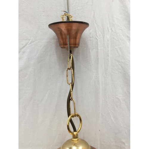 56 - AN UNUSUAL BRASS AND COPPER PENDANT LIGHT WITH DOMED GLASS SHADE, SHIPS WHEEL DESIGN AND CHAINS