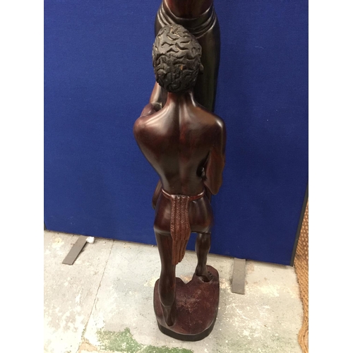 60A - A CARVED HARDWOOD TRIBAL STATUE OF A MAN LIFTING A WOMEN HEIGHT 167CM