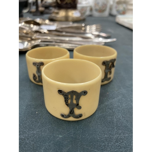 71 - THREE BONE NAPKIN RINGS WITH HALLMARKED LONDON SILVER INITIALS