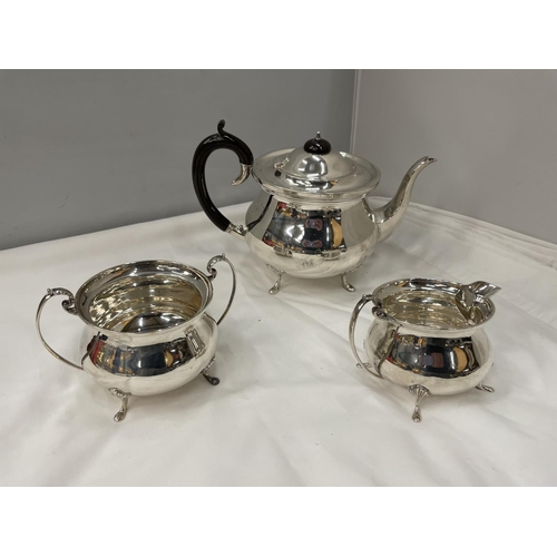 1 - A THREE PIECE HALLMARKED BIRMINGHAM SILVER TEA SET TO INCLUDE A TEAPOT, TWIN HANDLED SUGAR BOWL AND ... 