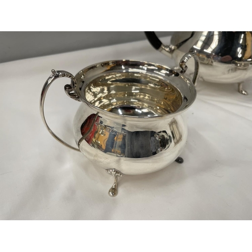 1 - A THREE PIECE HALLMARKED BIRMINGHAM SILVER TEA SET TO INCLUDE A TEAPOT, TWIN HANDLED SUGAR BOWL AND ... 