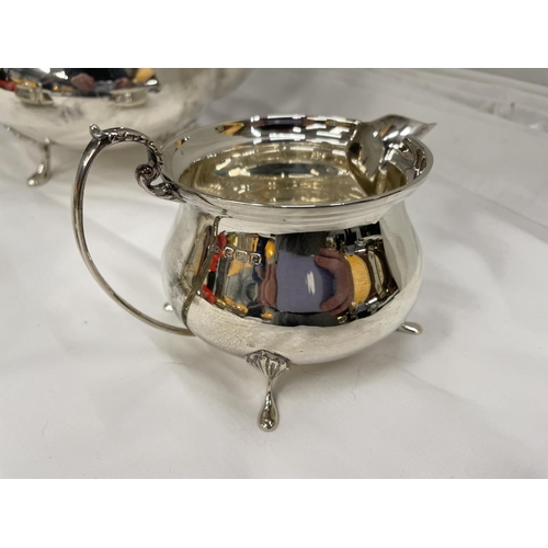 1 - A THREE PIECE HALLMARKED BIRMINGHAM SILVER TEA SET TO INCLUDE A TEAPOT, TWIN HANDLED SUGAR BOWL AND ... 