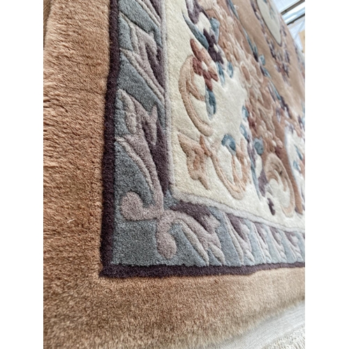 1991 - AN ORANGE PATTERNED FRINGED RUG