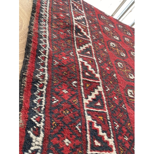 1993 - A RED PATTERNED FRINGED RUG