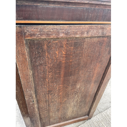 2504 - A GEORGE  III OAK CORNER CUPBOARD WITH SHAPED INTERIOR SHELVES, 30