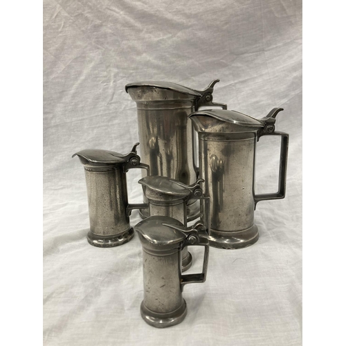 10 - A SET OF FIVE PEWTER GRADUATING MEASURING LIDDED JUGS MEASURING FROM LITRE TO DEMI-DECILITRE WITH TO... 
