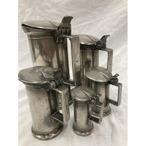10 - A SET OF FIVE PEWTER GRADUATING MEASURING LIDDED JUGS MEASURING FROM LITRE TO DEMI-DECILITRE WITH TO... 
