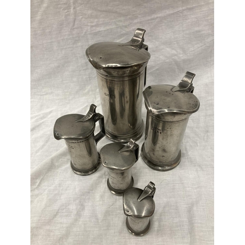 10 - A SET OF FIVE PEWTER GRADUATING MEASURING LIDDED JUGS MEASURING FROM LITRE TO DEMI-DECILITRE WITH TO... 