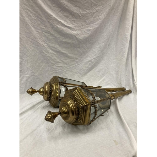 27 - A PAIR OF VINTAGE BRASS COACHING LAMPS - NOW CONVERTED TO ELECTRICITY, THE GLASS DECORATED WITH BRAS... 