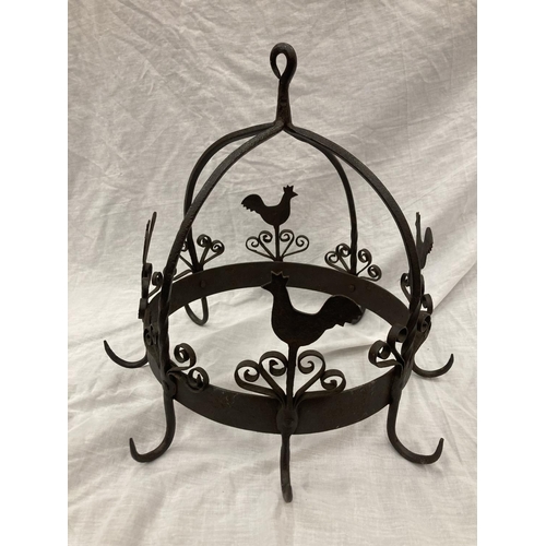 5 - A WROUGHT IRON HANGING UTENSIL HOLDER DECORATED WITH SCROLLS AND HENS HEIGHT 37CM, DIAMETER 30CM