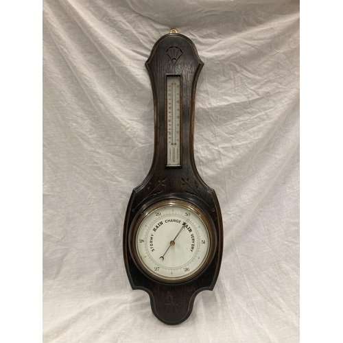 41 - A DARK OAK CASED VINTAGE CARVED BAROMETER - LENGTH APPROX 82CM