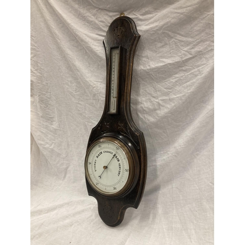 41 - A DARK OAK CASED VINTAGE CARVED BAROMETER - LENGTH APPROX 82CM