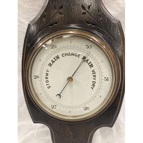 41 - A DARK OAK CASED VINTAGE CARVED BAROMETER - LENGTH APPROX 82CM