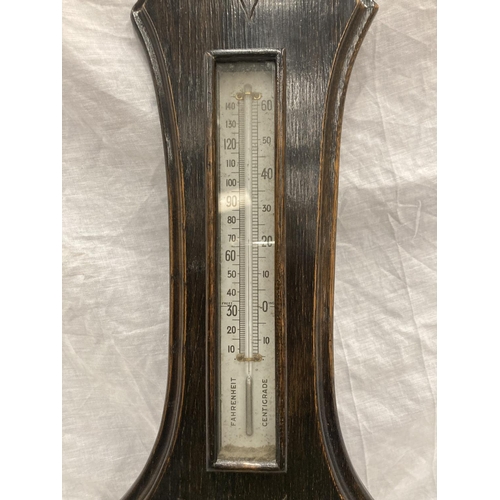 41 - A DARK OAK CASED VINTAGE CARVED BAROMETER - LENGTH APPROX 82CM