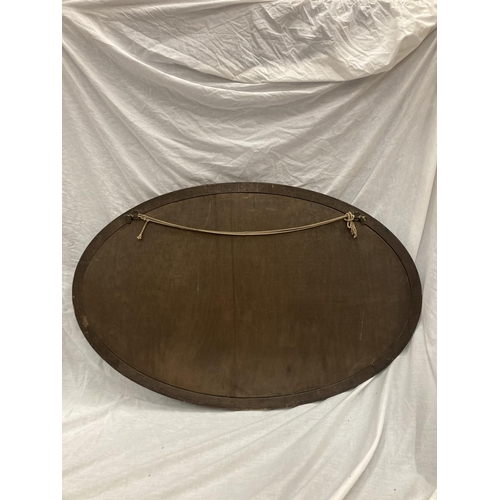 42 - A LARGE MAHOGANY FRAMED OVAL MIRROR WITH BEADED INNER APPROX 100CM X 65CM