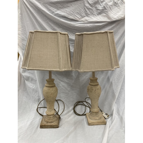 52 - A PAIR OF CREAM STONE LAMPS WITH SHADES - HEIGHT 54CM