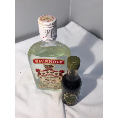 392 - A RARE BOTTLE OF SMIRNOFF 13 1/3 FL OZS AND 65.5 % PROOF PRODUCED IN ENGLAND TOGETHER WITH A 10CL HO... 