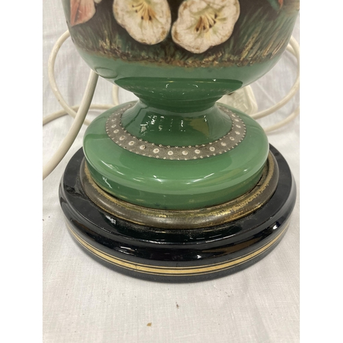 24 - A GREEN CERAMIC LAMP EMBOSSED WITH A FLOWER AND BUTTERFLY DESIGN