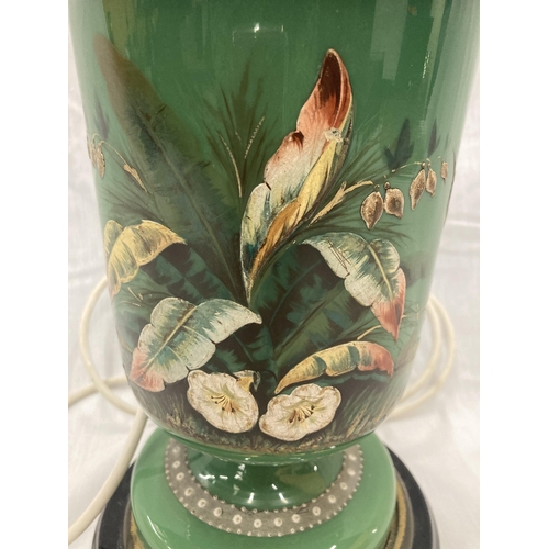 24 - A GREEN CERAMIC LAMP EMBOSSED WITH A FLOWER AND BUTTERFLY DESIGN