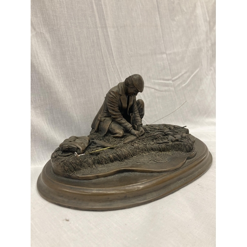 27 - A RESIN FIGURE OF A MAN FISHING ON A WOODEN PLINTH