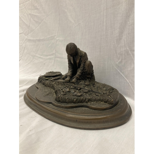 27 - A RESIN FIGURE OF A MAN FISHING ON A WOODEN PLINTH