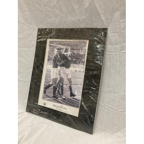 29 - A SIGNED BERT TRAUTMAN PICTURE OF HIM BEING HELPED LEAVING THE PITCH AT WEMBLEY AFTER PLAYING THE CU... 