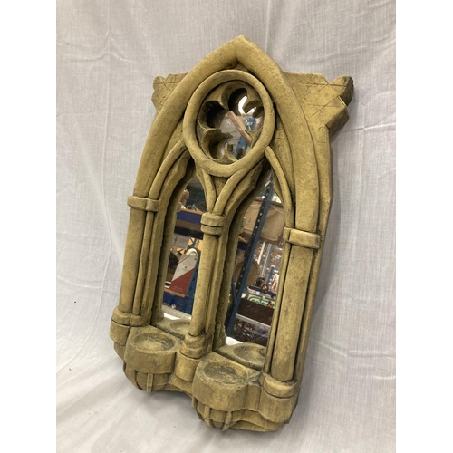 32 - A STONE FRAMED GOTHIC WINDOW STYLE MIRROR