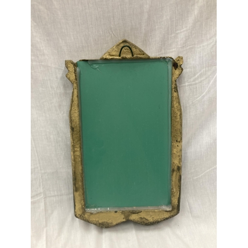 32 - A STONE FRAMED GOTHIC WINDOW STYLE MIRROR