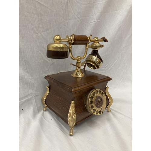 33 - A VINTAGE STYLE OAK TELEPHONE WITH BRASS DETAILING