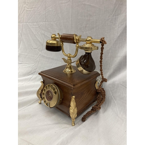 33 - A VINTAGE STYLE OAK TELEPHONE WITH BRASS DETAILING