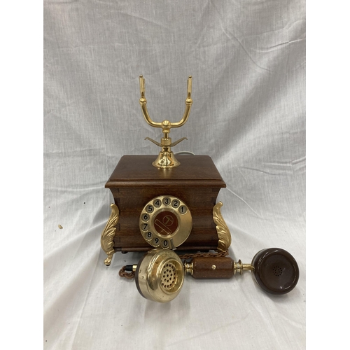 33 - A VINTAGE STYLE OAK TELEPHONE WITH BRASS DETAILING