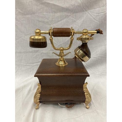 33 - A VINTAGE STYLE OAK TELEPHONE WITH BRASS DETAILING